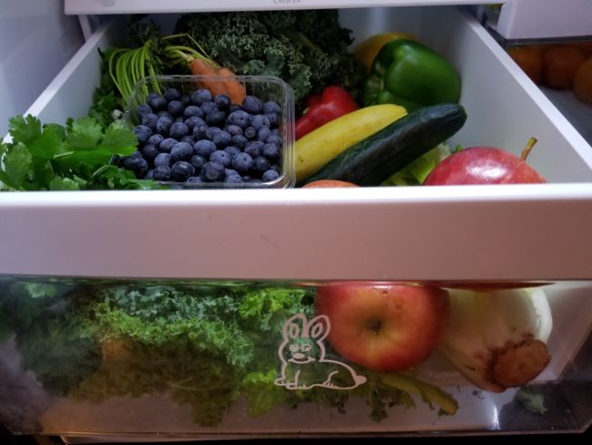 A drawer full of fruits and vegetables as an example of healthy fresh foods for rabbits